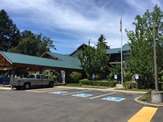 A transitional housing apartment building with covered breezeway and accessible parking.